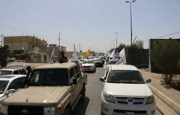 Iran-backed Iraqi militia Asaib Ahl al-Haq holds a military parade in a photo posted on X on May 7, 2021.