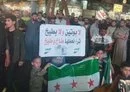 
A sign opposing Russia is raised in the Syrian city of al-Bab on June 12, during a demonstration to block the entry of Russian forces. [Radwan al-Shahwan X account]        