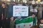 
A sign opposing Russia is raised in the Syrian city of al-Bab on June 12, during a demonstration to block the entry of Russian forces. [Radwan al-Shahwan X account]        