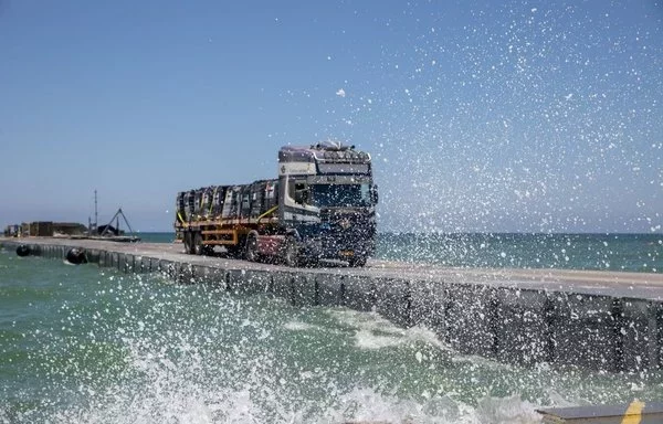 A truck transports aid into Gaza via a US-constructed temporary pier. [CENTCOM]