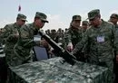 
Cambodian military commander-in-chief Vong Pisen (center) and Chinese People's Liberation Army (PLA) Southern Theater Command's Vice Admiral Gao Xiucheng (right) inspect a gun at a military police base in Kampong Chhnang province, Cambodia, on May 16. [Tang Chhin Sothy/AFP]        