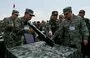 
Cambodian military commander-in-chief Vong Pisen (center) and Chinese People's Liberation Army (PLA) Southern Theater Command's Vice Admiral Gao Xiucheng (right) inspect a gun at a military police base in Kampong Chhnang province, Cambodia, on May 16. [Tang Chhin Sothy/AFP]        