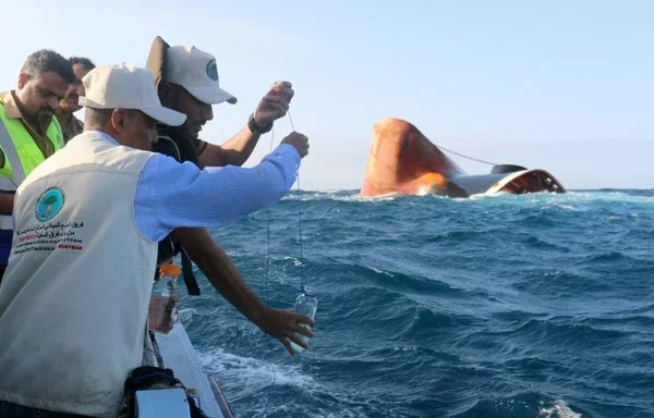 A field survey team takes water samples during a visit to the Rubymar freighter off the coast of Yemen on March 23. [Khaled Ziad/AFP]