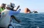 
A field survey team takes water samples during a visit to the Rubymar freighter off the coast of Yemen on March 23. [Khaled Ziad/AFP]        