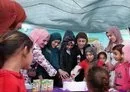 
Iraqi Minister of Migration and Displacement Evan Gabro slices a cake with girls at al-Jadaa Rehabilitation Center near Mosul on March 9. [Evan Gabro X account]        