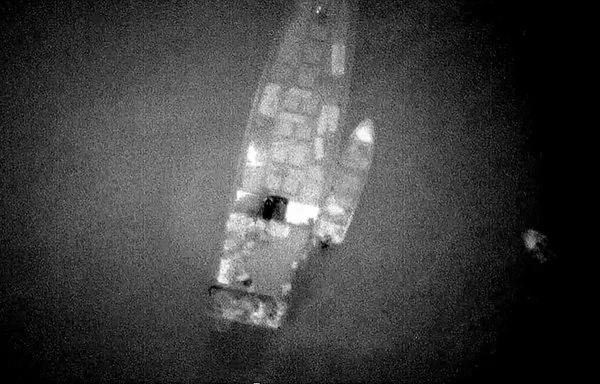 Aerial photographs taken recently purportedly show a rendezvous between a large Russian ship and smaller Houthi boats, which then ferried crates to shore. [US Government]