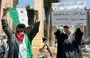 
A demonstrator in Idlib holds a sign denouncing Tahrir al-Sham's rule July 26. [Aleppo Fox]        