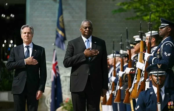 US Secretary of State Antony Blinken and Defense Secretary Lloyd Austin take part in a ceremony at the US Naval Academy on August 6. [Drew Angerer/AFP]