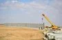 
Construction proceeds March 20 to complete a concrete wall on the Iraqi-Syrian border. [Iraqi Border Forces Command]        