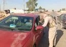 
An Iraqi security officer inspects a car in Diyala province on May 12. [Iraqi Ministry of Interior]        