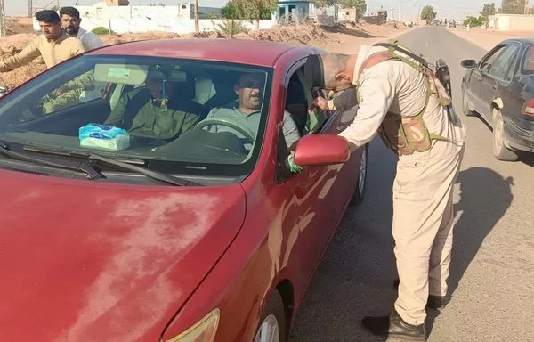 An Iraqi security officer inspects a car in Diyala province on May 12. [Iraqi Ministry of Interior]