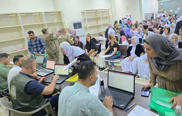 Displaced Yazidi families register to return to their hometowns on July 8. [Iraqi Ministry of Migration and Displacement]