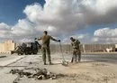 
Two US soldiers clear rubble at Ain al-Asad air base in western Iraq on January 13, 2020, days after an Iran attack on the base. [Ayman Henna/AFP]        