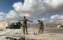 
Two US soldiers clear rubble at Ain al-Asad air base in western Iraq on January 13, 2020, days after an Iran attack on the base. [Ayman Henna/AFP]        