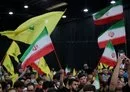 
People wave Iranian and Hizbullah flags during a rally to mourn the death of Iranian President Ebrahim Raisi, in Beirut's southern suburb on May 24. [Anwar Amro/AFP]        