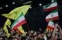 
People wave Iranian and Hizbullah flags during a rally to mourn the death of Iranian President Ebrahim Raisi, in Beirut's southern suburb on May 24. [Anwar Amro/AFP]        