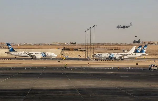 A US Air Force C-130 Hercules military transport aircraft lands near EgyptAir planes on the tarmac at Cairo International Airport in Cairo on June 3. [Amir Makar/AFP]