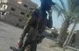 
An armed member of an IRGC-affiliated militia walks through a Deir Ezzor province border town. [File]        