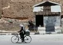 
A Syrian rides his bicycle on August 1, 2013, in al-Qusayr in Syria's Homs province. [Joseph Eid/AFP]        