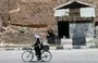 
A Syrian rides his bicycle on August 1, 2013, in al-Qusayr in Syria's Homs province. [Joseph Eid/AFP]        