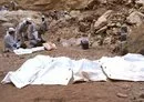 
Experts retrieve the remains of ISIS victims from the Alo Antar hole in Tal Afar. [Zaid al-Obeidi/AFP]        