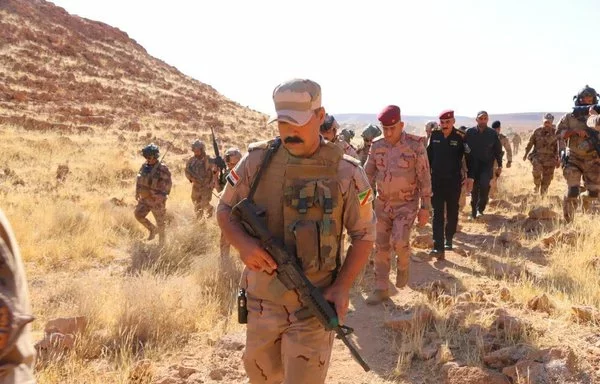 Iraqi commanders inspect the site of the joint US-Iraqi raid on ISIS strongholds in Wadi al-Qadhf, September 1. [Iraqi Security Media Cell]