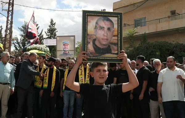 Mourners attend the funeral of a Hizbullah element in the town of Chaat in Lebanon's Bekaa valley on September 21. [AFP]