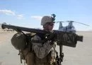 
A US Marine carries a stinger weapon system before loading onto a CH-46 Sea Knight helicopter at Marine Corps Air Ground Combat Center Twentynine Palms, California, on February 3, 2014. [US Marine Corps]        