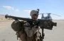 
A US Marine carries a stinger weapon system before loading onto a CH-46 Sea Knight helicopter at Marine Corps Air Ground Combat Center Twentynine Palms, California, on February 3, 2014. [US Marine Corps]        