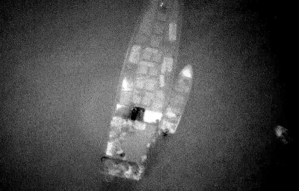 Aerial photographs purportedly show a rendezvous between a large Russian ship and smaller Houthi boats, which then ferried crates to shore. [US Government]