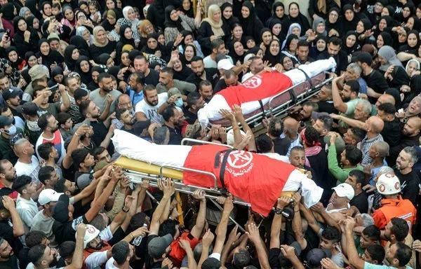 Residents of Nahr al-Bared Palestinian refugee camp in northern Lebanon gather September 30 for the funeral of Popular Front for the Liberation of Palestine commanders. [Fathi al-Masri/ AFP]