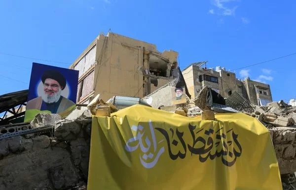 A picture taken October 2 shows portraits of slain Hizbullah leader Hassan Nasrallah on the rubble of a building in Beirut's southern suburb. [AFP]