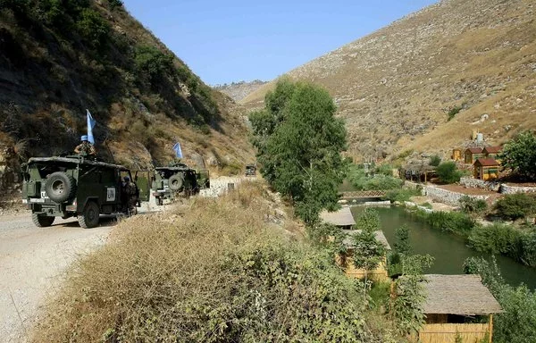 UNIFIL soldiers patrol along the Litani river near the southern Lebanese village of Shuhur in September 2006. [Thomas Coex/AFP]