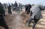 
Mourners during a mass funeral for Yazidi victims of ISIS whose remains were found in a mass grave in the northern Iraqi village of Kojo in 2021. [Zaid AL-OBEIDI / AFP]        