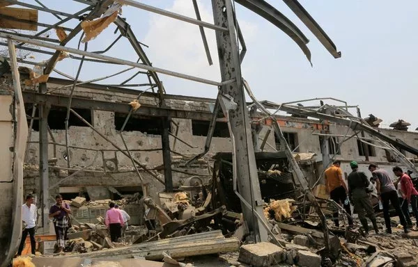 People check the destruction at an al-Hodeidah city power station on September 30, a day after it was targeted in retaliatory Israeli strikes. [AFP]