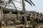 
People check the destruction at an al-Hodeidah city power station on September 30, a day after it was targeted in retaliatory Israeli strikes. [AFP]        