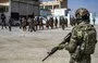 
Syrian Kurdish security forces stand by as former detainees suspected of being ISIS members are released in Syria's northeastern city of Hasakeh on September 2. [Delil Souleiman/AFP]        