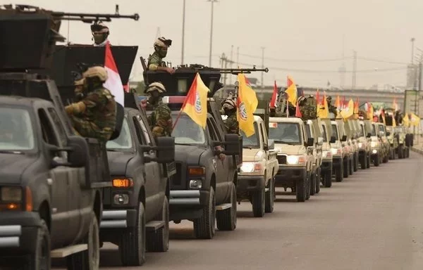 Fighters from the Iran-backed Iraqi militia Sayed al-Shuhada, which operates in the Iraq-Syria border region, exhibit their weaponry during a rally, in a photo posted on X on April 9, 2020.