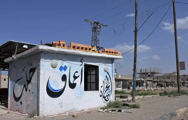 A building bearing the name of ISIS's propaganda agency, Amaq, is seen in the Syrian town of Maskanah on June 5, 2017. [George Ourfalian/AFP]