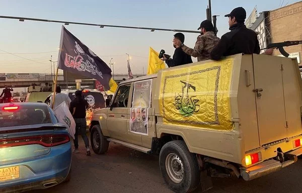 Fighters from Iran-aligned Iraqi militia Harakat al-Nujaba, which has taken part in regional attacks, are seen riding in a truck in a photo circulated on X on June 3.