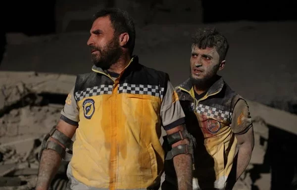 White Helmets work after a Russian air strike destroyed a furniture workshop near Idlib on October 17, killing at least 10 people and wounding 30 others. [Omar Haj Kadour/AFP]