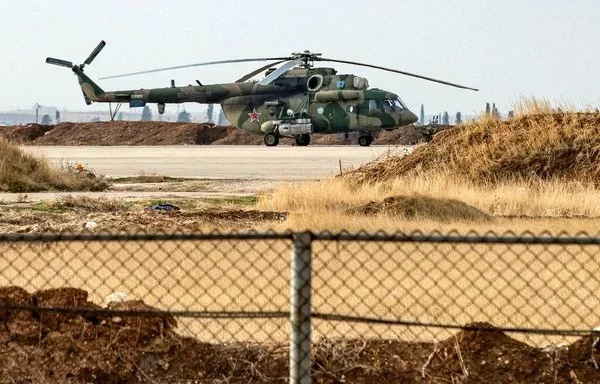 A Russian military helicopter is shown at the Russian air base at Qamishli Airport in Syria on December 12. The future of Russia's bases in Syria is uncertain. [Delil Souleiman/AFP]