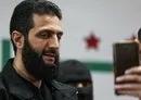 
A man takes a picture with his mobile phone of Syria's de facto new leader, Ahmed al-Sharaa, previously referred to as Abu Mohammed al-Joulani, on March 12, 2024. [Omar Haj Kadour/AFP]        