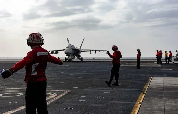 Sailors direct an F/A-18E Super Hornet on the flight deck of the USS Harry S. Truman aircraft carrier in the Red Sea on January 6. [US Navy]