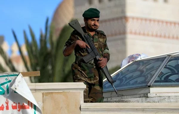 An armed guard chews qat in Houthi-controlled Sanaa on November 1, 2024. [Mohammed Huwais/AFP]