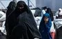 
A woman and child walk in al-Hol camp in Syria's al-Hasakeh province on July 28, 2024. [Delil Souleiman/AFP]        